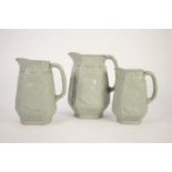 J T DUDSON GRADUATED TRIO OF MOULDED GREEN STONEWARE OCTAGANOL FORM COMMEMORATIVE JUGS with bust