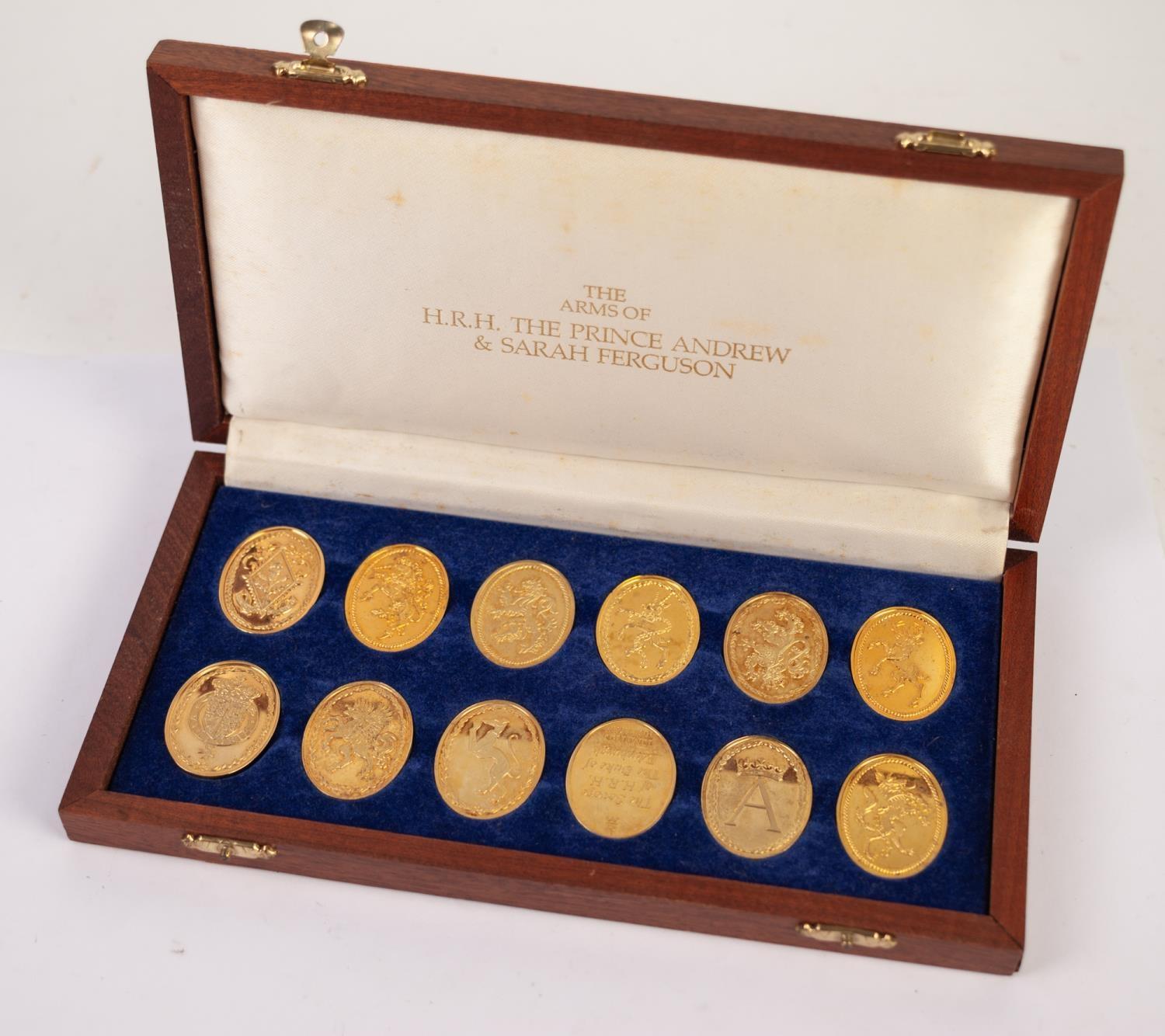 SET OF TWELVE OVAL SILVER GILT MEDALLIONS RELATING TO "THE ARMS OF HRH THE PRINCE ANDREW AND SARAH