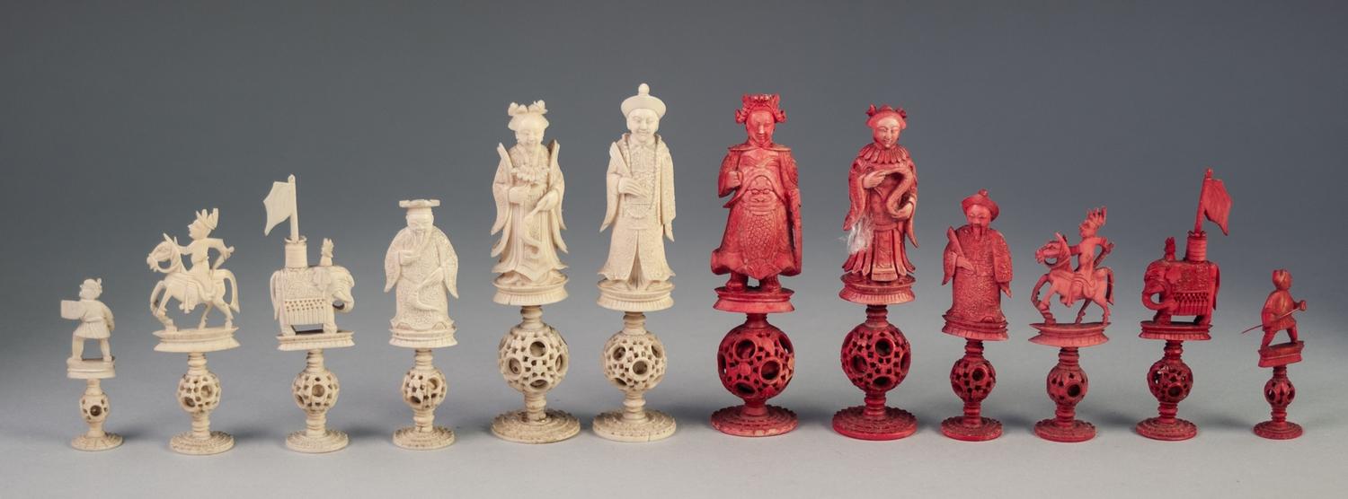 32 PIECE CHINESE (CANTON) LATE QING DYNASTY CARVED NATURAL AND RED STAINED IVORY CHESS SET each with