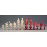 32 PIECE CHINESE (CANTON) LATE QING DYNASTY CARVED NATURAL AND RED STAINED IVORY CHESS SET each with