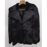 LADY'S BLACK DYED FUR THREE-QUARTER LENGTH COAT with broad revere collar, hook fastening double