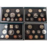 FOUR QUEEN ELIZABETH II PROOF COIN SETS each in hard plastic display with outer soft plastic blue
