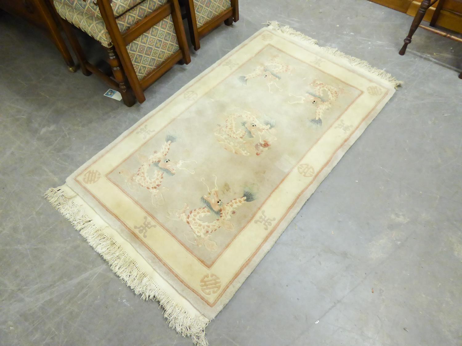 EMBOSSED WASHED CHINESE RUG, WITH CENTRE MEDALLION AND A DRAGON TO EACH CORNER, MUSHROOM COLOURED