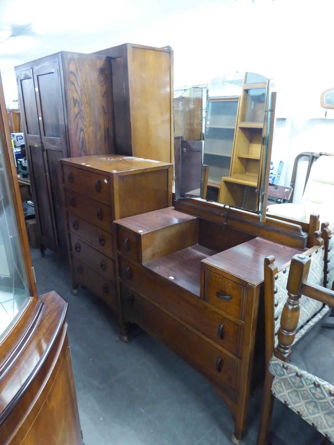 AN OAK TALLBOY CHEST OF FIVE DRAWERS AND MATCHING SUNK CENTRE DRESSING TABLE AND AN OAK TWO DOOR