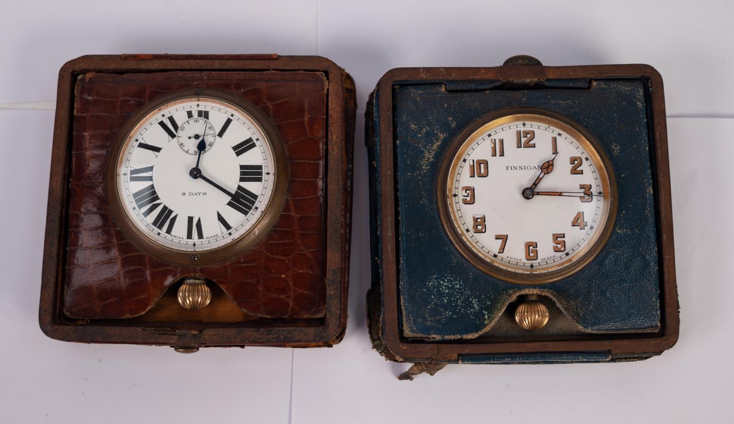 TWO POCKET WATCHES ON STANDS To include a Finnigans pocket watch in blue leather case, together with