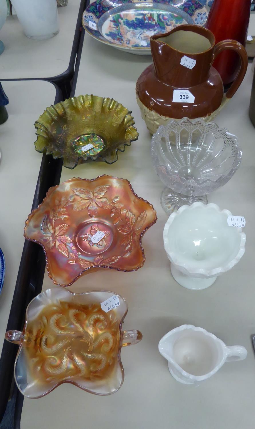 THREE CARNIVAL GLASS BOWLS; A VICTORIAN MILK GLASS CREAM JUG AND PEDESTAL SUGAR BOWL; A VICTORIAN