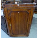 A LARGE GEORGE III OAK AND MAHOGANY CROSSBANDED HANGING CORNER CUPBOARD