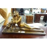 ART DECO BRONZE PAINTED PLASTER GROUP GIRL IN A TWO PIECE BATHING COSTUME LYING ALONGSIDE A DOG,