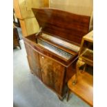 A FIGURED MAHOGANY TWO DOOR SERPENTINE RADIOGRAM CABINET WITH LIFT-UP TOP