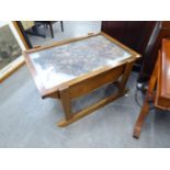 AN UNUSUAL OAK SLEDGE SHAPED COFFEE TABLE WITH GLAZED HOT PLATE TOP WITH DECORATIVE INCA FIGURES 32"