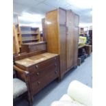A 1930's CARVED OAK SINGLE DOOR WARDROBE, 3'10" WIDE AND AN OAK CHEST OF THREE LONG DRAWERS