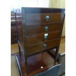 A 1930's WALNUTWOOD MUSIC CABINET WITH FOUR FALL FRONT DRAWERS, ON STRAIGHT SUPPORTS