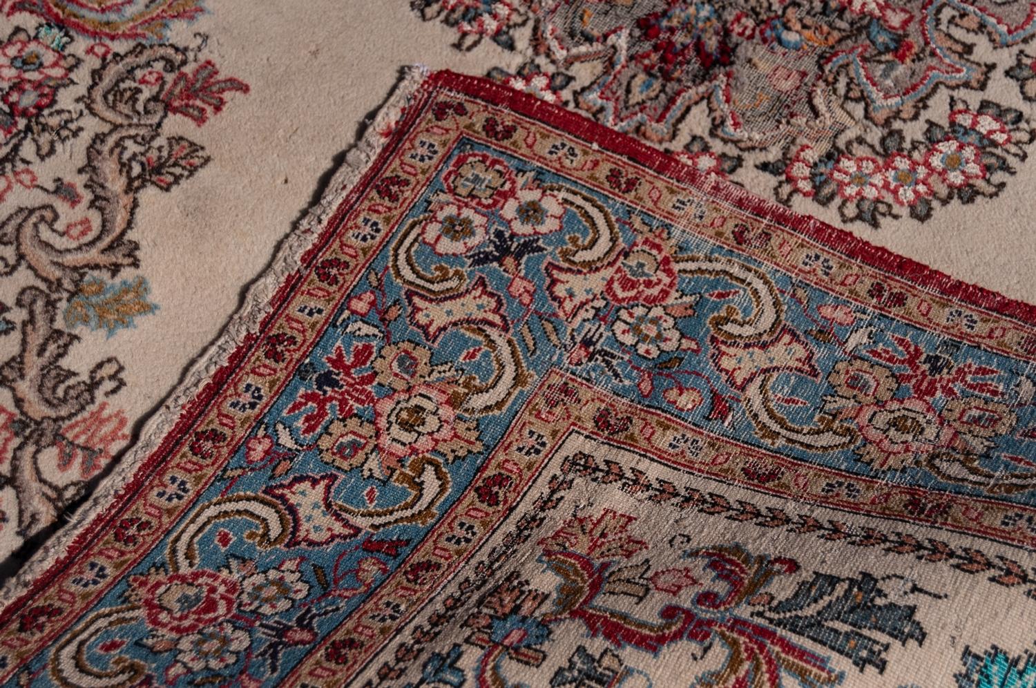 QUM PERSIAN WOOL RUG with floral centre medallion with pendant and surround, on plain white field, - Image 3 of 3