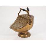 AN ATTRACTIVE LATE VICTORIAN/EDWARDIAN BRASS HELMET SHAPED COAL SCUTTLE with cast brass and turned