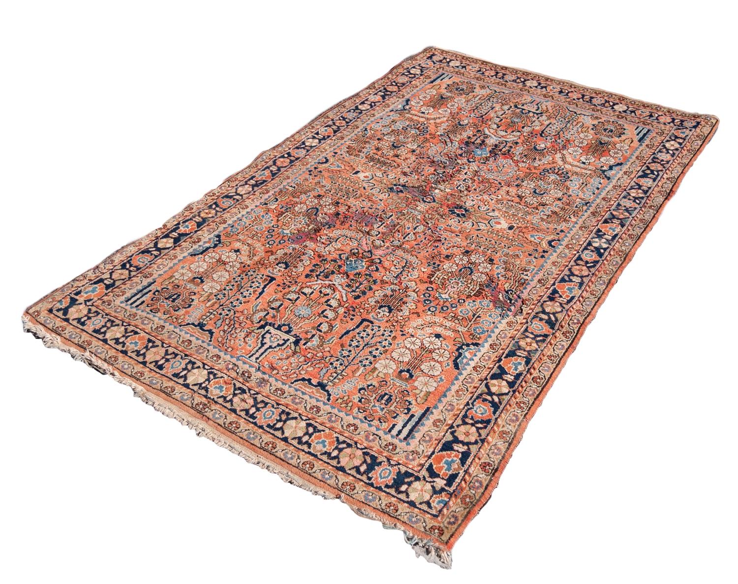 SAROUK PERSIAN RUG with all-over design of vases of stylised flowering shrubs on a pink field,