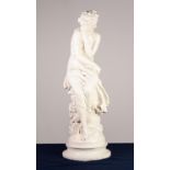 WHITE PAINTED PLASTER FIGURE OF A SEMI NAKED CLASSICAL FEMALE FIGURE, modelled seated, on a circular