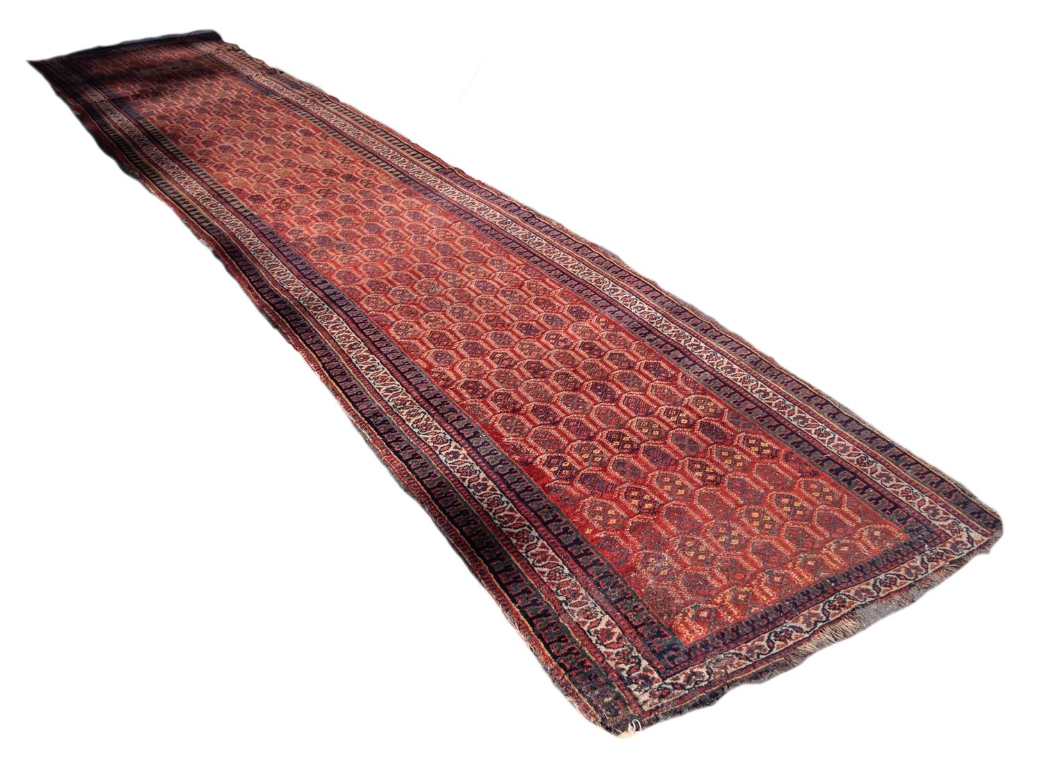 ZANDAN PERSIAN RUNNER with all-over Boteh design on a crimson field, narrow off-white principal