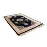 HEAVY QUALITY WASHED CHINESE EMBOSSED CARPET with circular centre floral medallion and spandrels