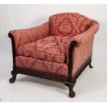 VICTORIAN WARING AND GILLOWS CARVED MAHOGANY FRAMED EASY ARMCHAIR, the shaped low back set above