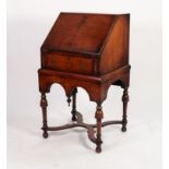 A FIGURED WALNUT VENEERED SMALL BUREAU sloping fall front on long drawer below over a deep double