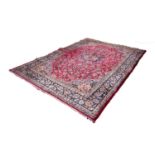 KIRMAN PERSIAN HAND-MADE CARPET with circular petal form centre medallion in midnight blue with
