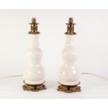 PAIR OF MODERN GILT METAL MOUNTED WHITE POTTERY TABLE LAMPS, each of double gourd form with scroll