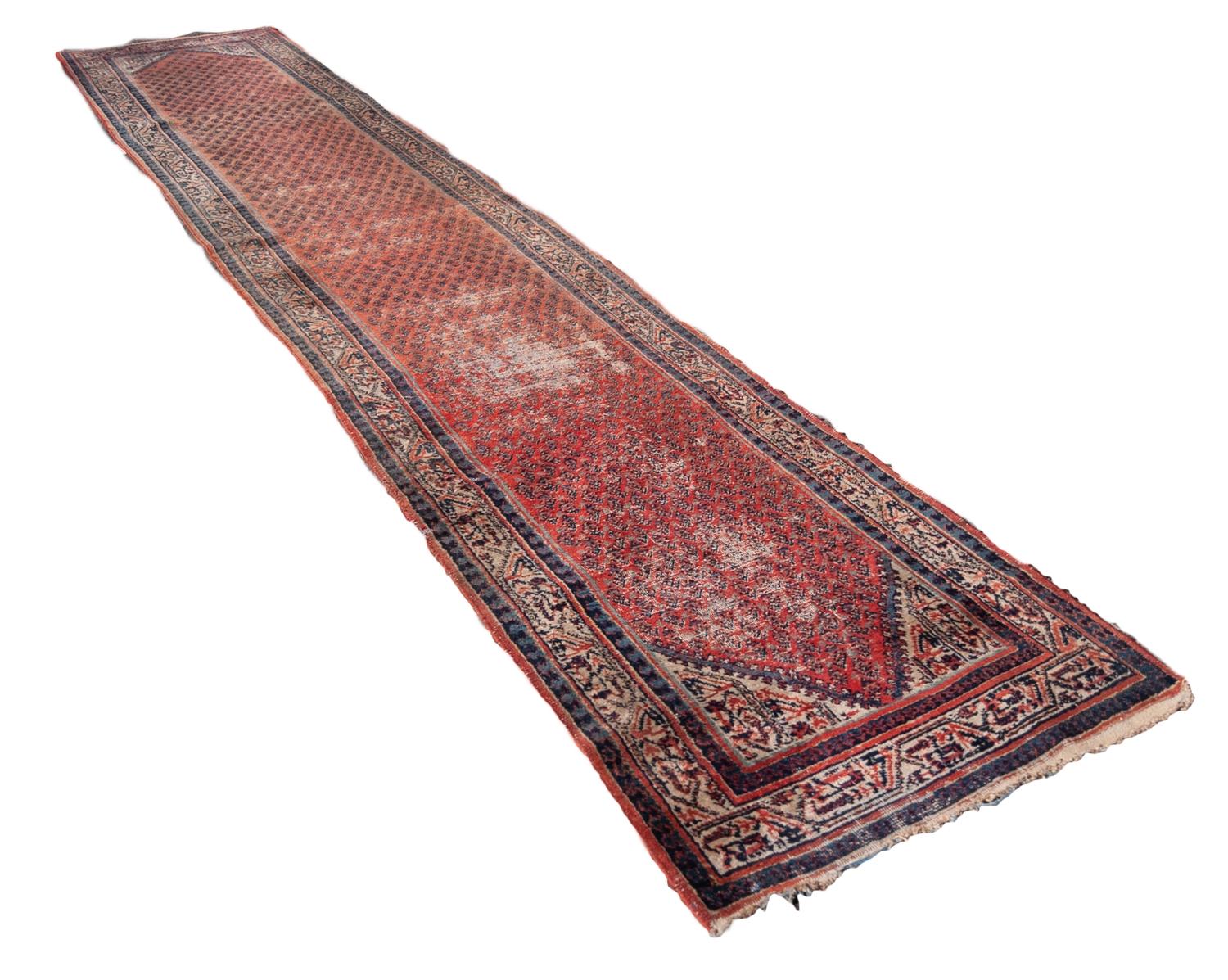 MIR SARABEND PERSIAN RUG, with all-over boteh design on a red/pink field with off-white spandrels,