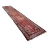 MIR SARABEND PERSIAN RUG, with all-over boteh design on a red/pink field with off-white spandrels,