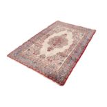 QUM PERSIAN WOOL RUG with floral centre medallion with pendant and surround, on plain white field,