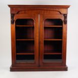 VICTORIAN MAHOGANY BOOKCASE, the moulded cornice above a pair of glazed cupboard doors, enclosing