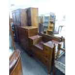 AN OAK TALLBOY CHEST OF FIVE DRAWERS AND MATCHING SUNK CENTRE DRESSING TABLE AND AN OAK TWO DOOR