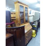 A PINE BUREAU BOOKCASE, THE UPPER SECTION HAVING TWO GLAZED DOORS, THE BASE HAIVNG FALL-FRONT OVER