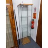 AN IKEA TALL NARROW GLASS DISPLAY CABINET WITH KEY