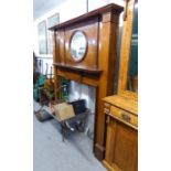 AN EDWARDIAN MAHOGANY LARGE FIRE SURROUND WITH OVAL MIRROR ABOVE A MANTEL SHELF