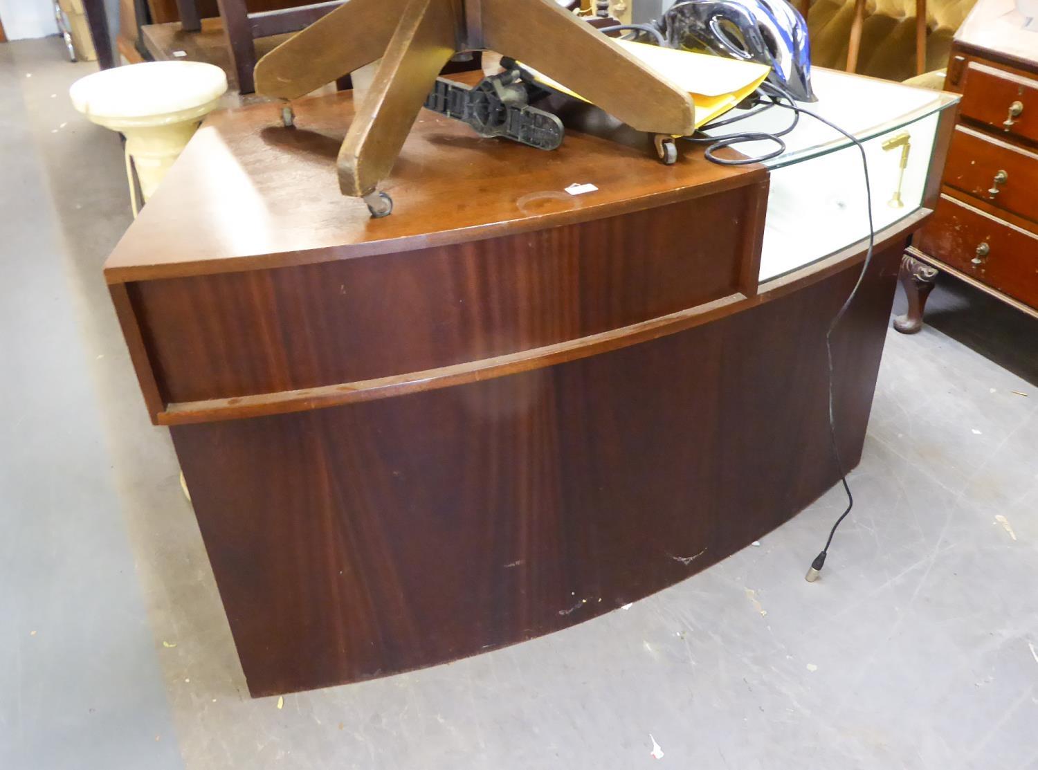 A WOOD AND GLASS CURVED DISPLAY CABINET