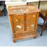 AN ORIENTAL LACQUERED AND PAINTED SMALL CABINET, WITH TWO SMALL DOORS OVER A SINGLE DRAWER