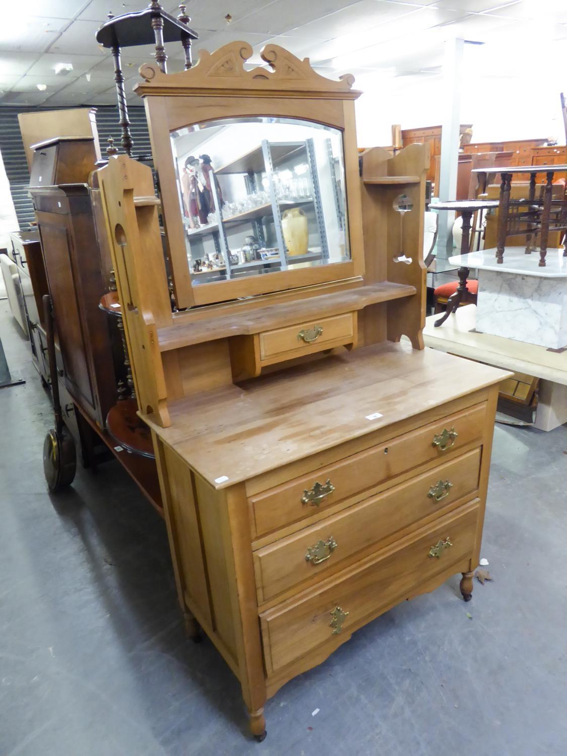 A SATIN WQOOD DRESSING TABLE OF 3 LONG GRADUATED DRAWERS AND SWING MIRROR