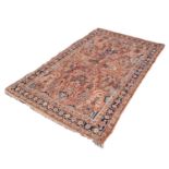 SAROUK PERSIAN RUG with all-over design of vases of stylised flowering shrubs on a pink field,