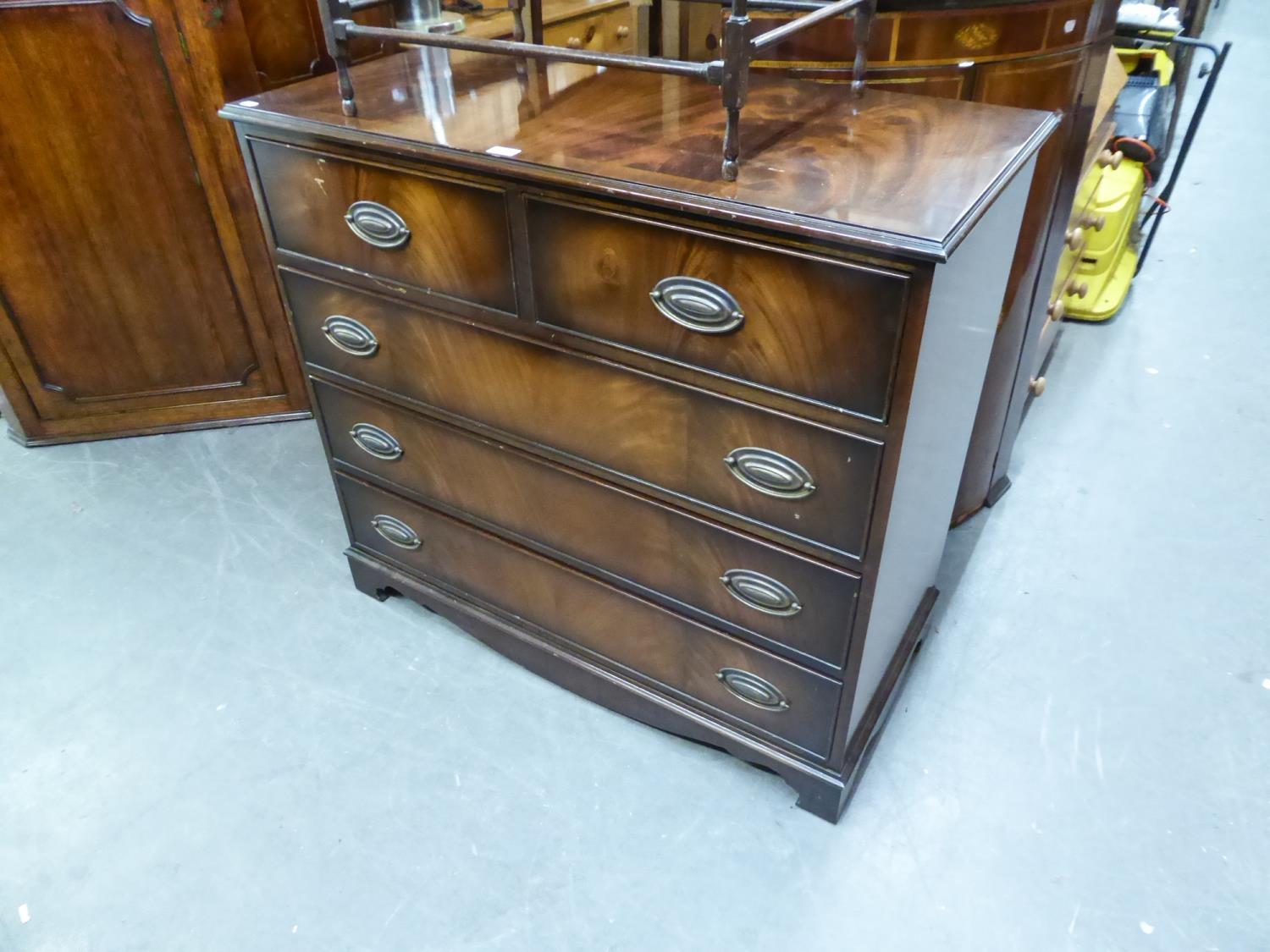 A FLAME MAHOGANY CHEST OF TWO SHORT AND THREE LONG DRAWERS