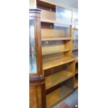 A TEAK FIVE TIER SECTIONAL BOOKCASE WITH GLASS SLIDING DOORS
