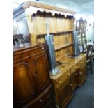 A PINE WELSH DRESSER, THE BASE HAVING 3 DRAWERS OVER 3 CUPBOARDS AND THE UPPER SECTION HAVING AN