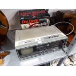 A SHARP COMBINED SMALL SCREEEN PORTABLE TV, RADIO AND CLOCK AND A DIRT DEVIL HAND VACUUM CLEANER,