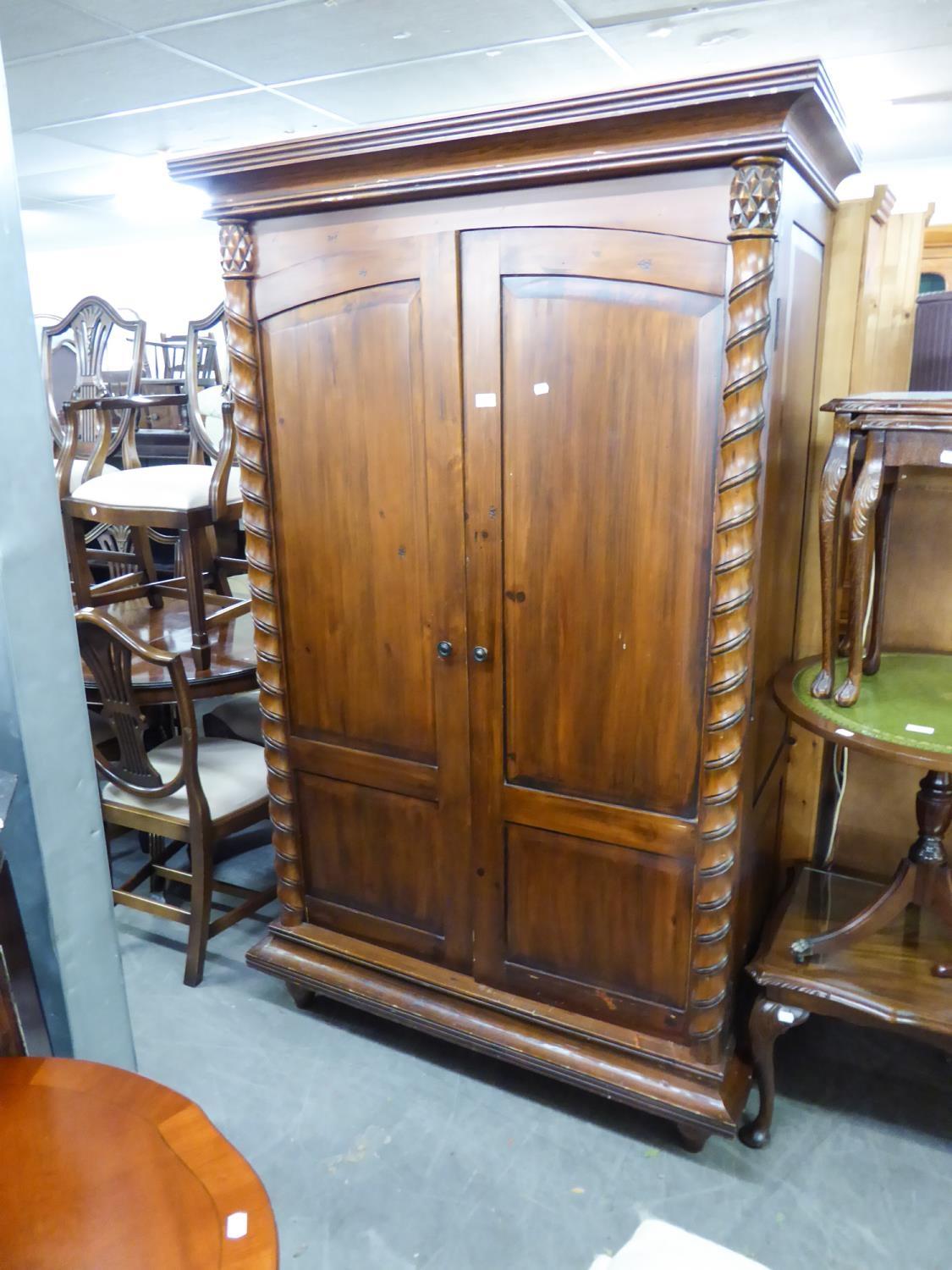 A STAINED WOOD LARGE TWO DOOR WARDROBE, WITH TWISTING COLUMN DECORATION
