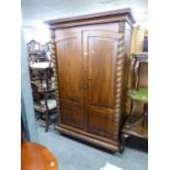 A STAINED WOOD LARGE TWO DOOR WARDROBE, WITH TWISTING COLUMN DECORATION