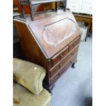 A MAHOGANY BUREAU, WITH SLOPING FALL-FRONT AND THREE LONG DRAWERS