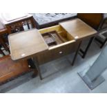 A WOODEN SEWING TABLE, WITH SPRING OPENING TWO PART TOP, INTERIOR LIFT-OUT TRAY, ON FOUR STRAIGHT