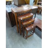 A CHINESE NEST OF FOUR COFFEE TABLES, WITH CARVED DECORATION, RAISED ON STRAIGHT LEGS