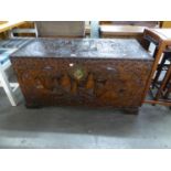 A CHINESE CARVED CAMPHOR WOOD STORAGE TRUNK (44" WIDE, 22" DEEP, 23" HIGH)