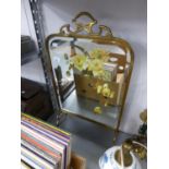 AN EDWARDIAN BRASS FRAMED BEVELLED AND FLORAL PAINTED GLASS FIRESCREEN