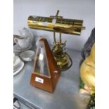 A BRASS DESK LAMP AND A METRONOME